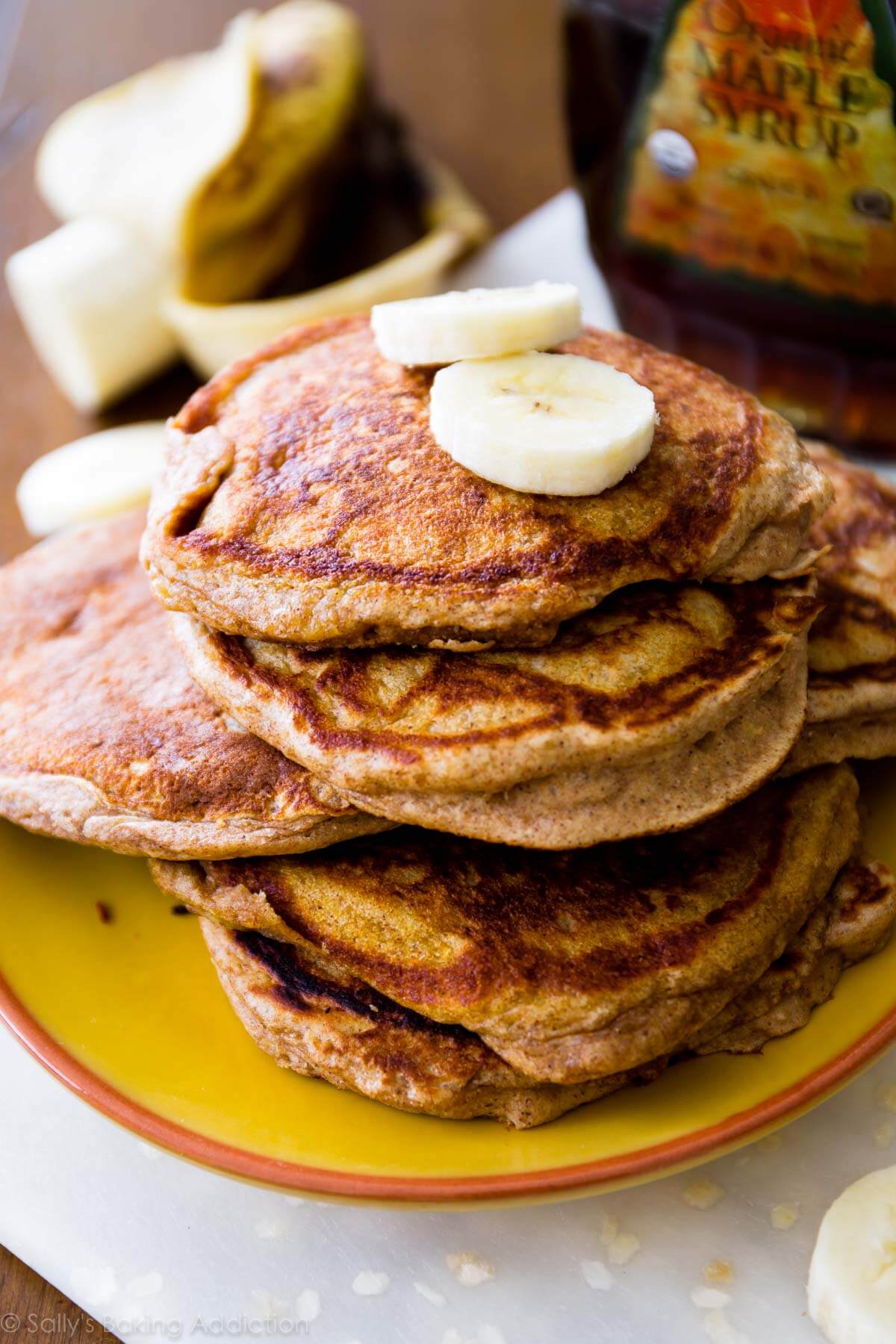 stack of whole wheat banana pancakes on a yellow plate