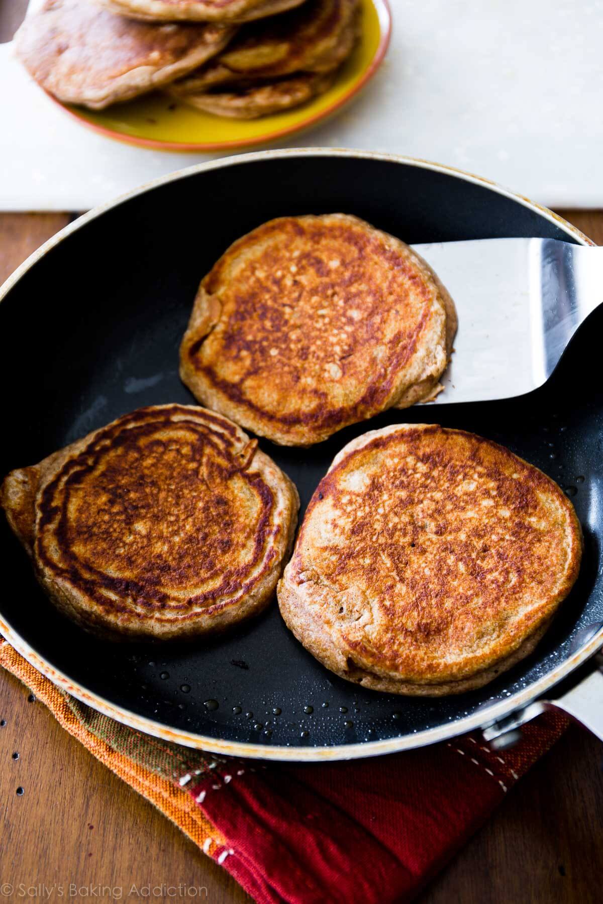 whole wheat banana pancakes in a skillet