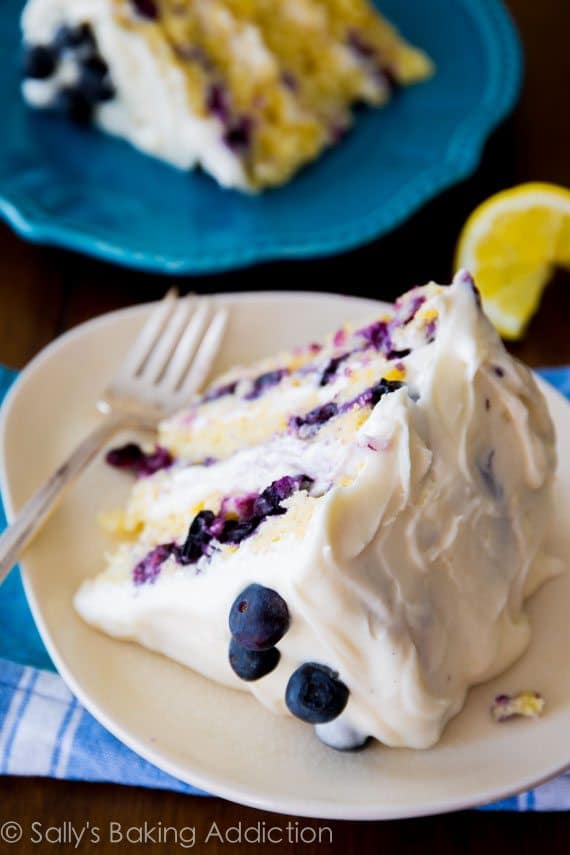 Deliciously sweet and light Lemon Blueberry Layer Cake. Tangy cream cheese frosting gives each bite a sweet touch!