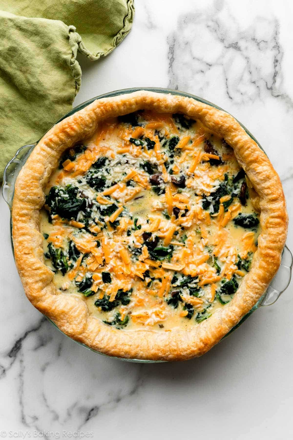 cheese and spinach egg filling in par-baked pie crust.