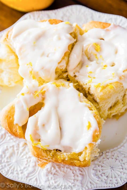 lemon sweet rolls with lemon cream cheese frosting on a white plate