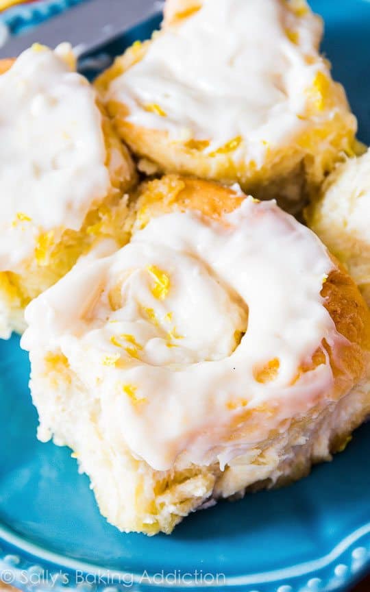 lemon sweet rolls with lemon cream cheese frosting on a blue plate