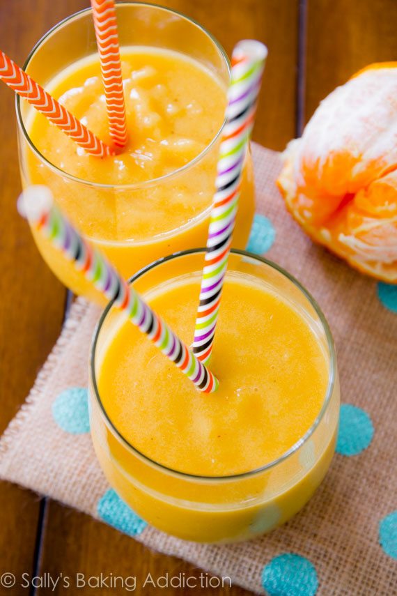 sunshine smoothie in glasses with straws