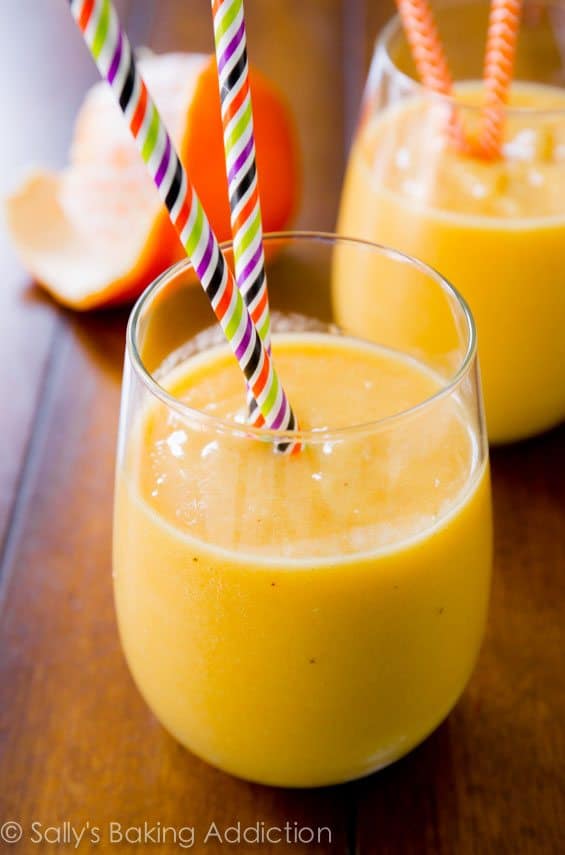 sunshine smoothie in a glass with straws