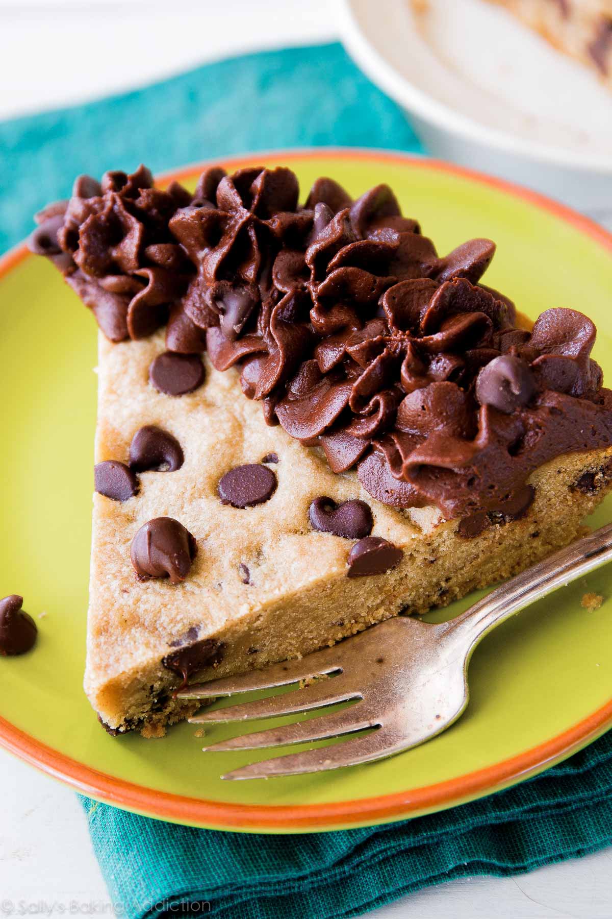 slice of chocolate chip cookie cake on a green plate