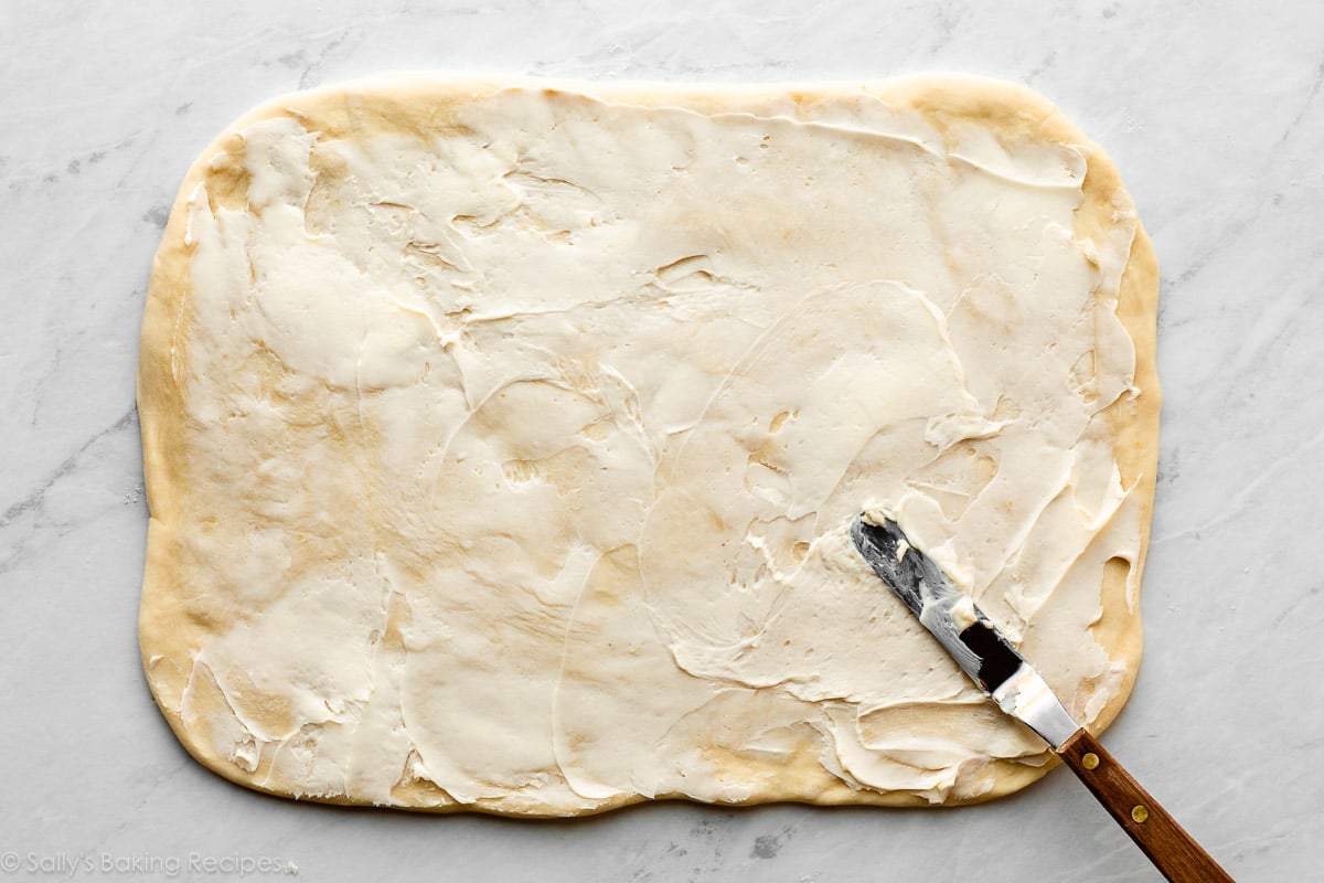 dough in shape of rectangle covered in softened butter.