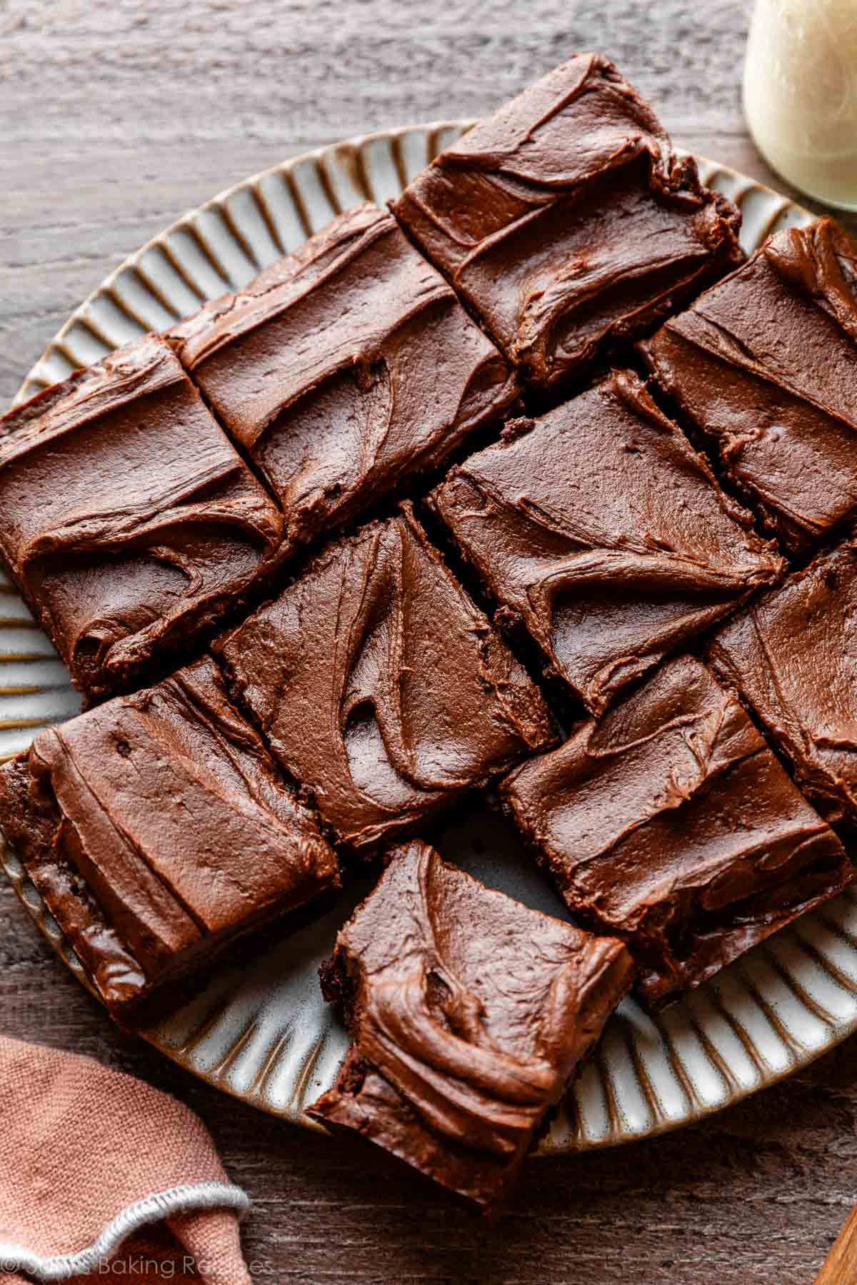 plate of chocolate frosted brownies cut into squares.