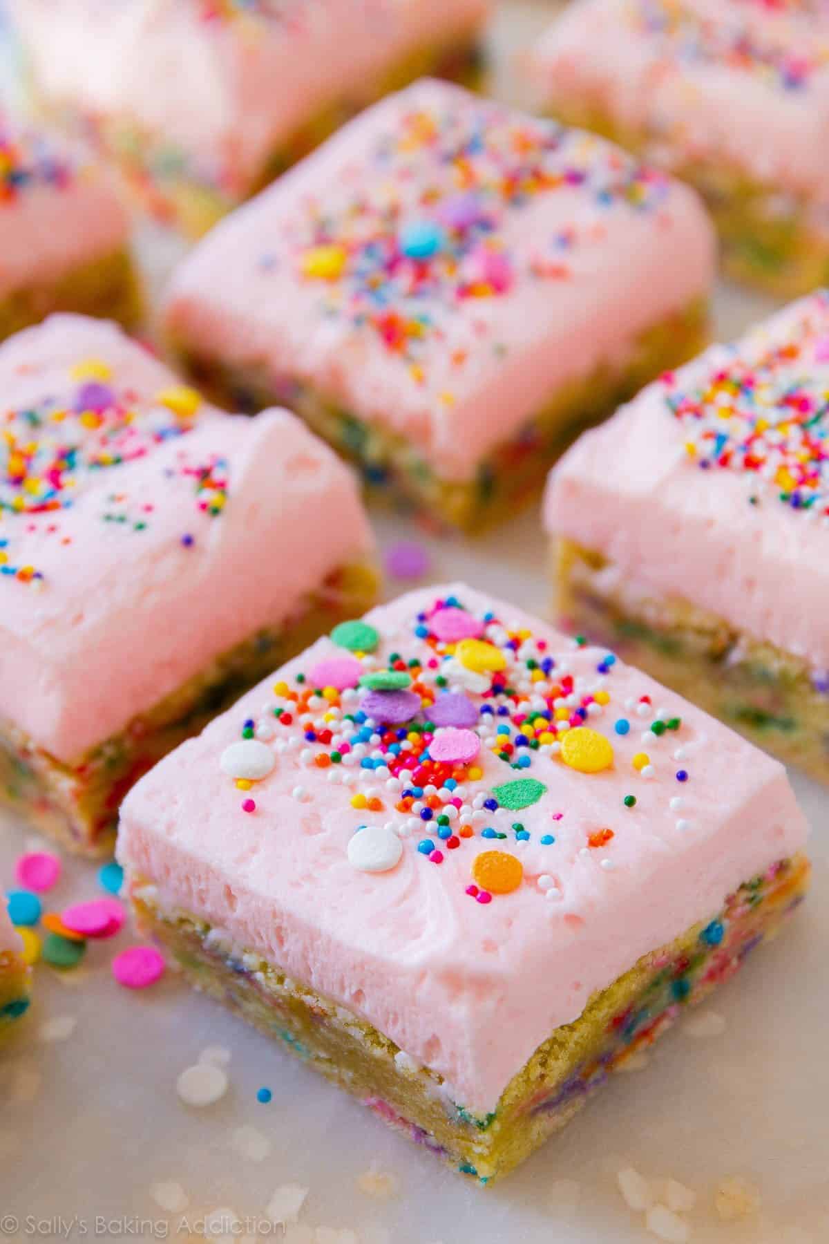 sugar cookie bars with pink frosting and sprinkles