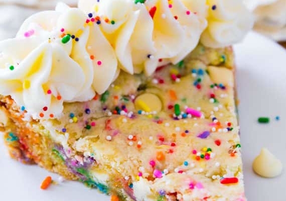 slice of funfetti sugar cookie cake on a white plate