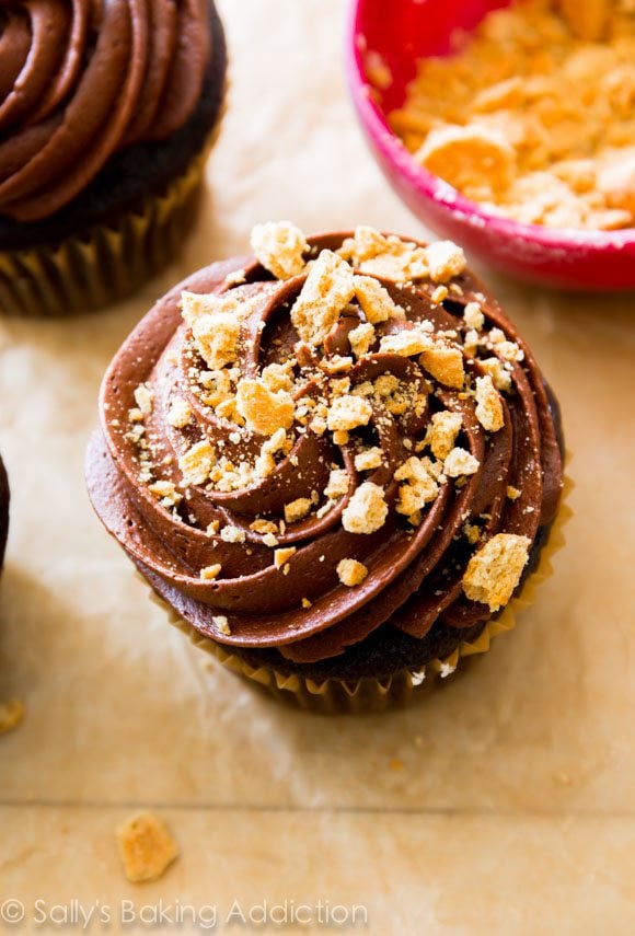 chocolate cupcake topped with chocolate frosting and crushed graham crackers