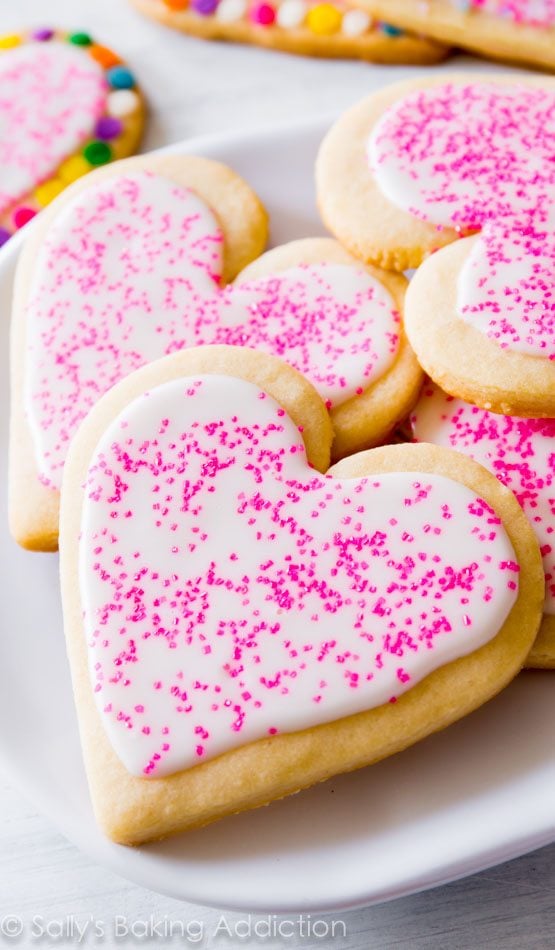 heart sugar cookies with royal icing and pink sprinkles
