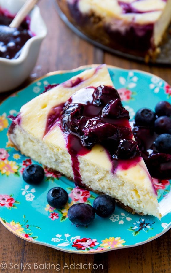 slice of blueberry swirl cheesecake on a blue floral plate