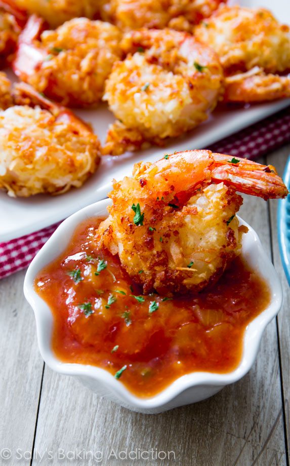 coconut shrimp in a white bowl of dipping sauce