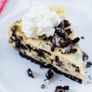 slice of cookies and cream cheesecake on a white plate