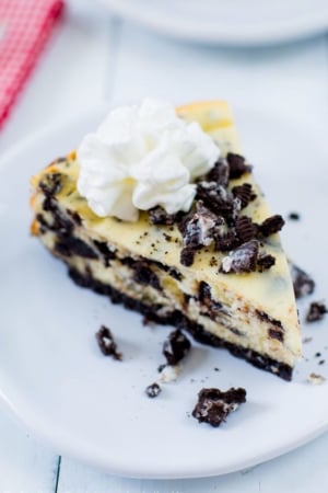 slice of cookies and cream cheesecake on a white plate