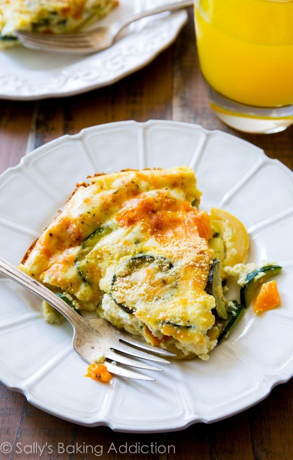 slice of crustless veggie quiche on a white plate with a fork
