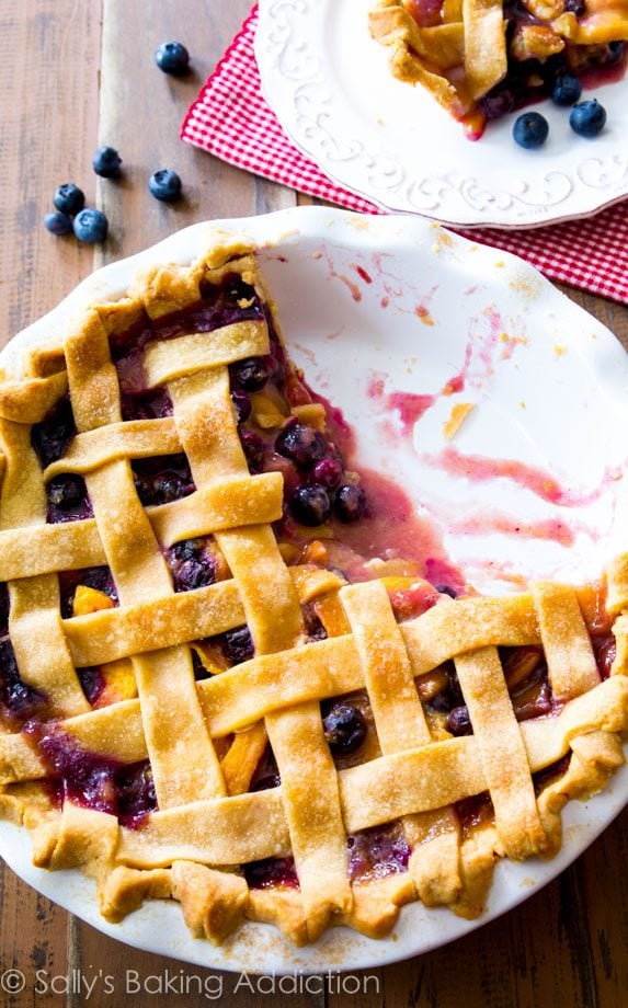 blueberry peach pie in a white pie dish