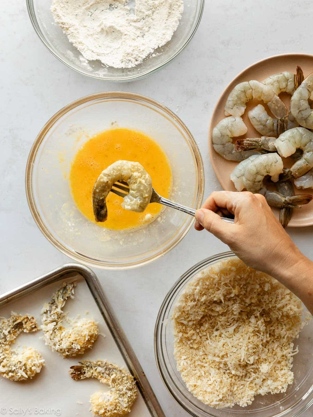 dipping shrimp into egg mixture.