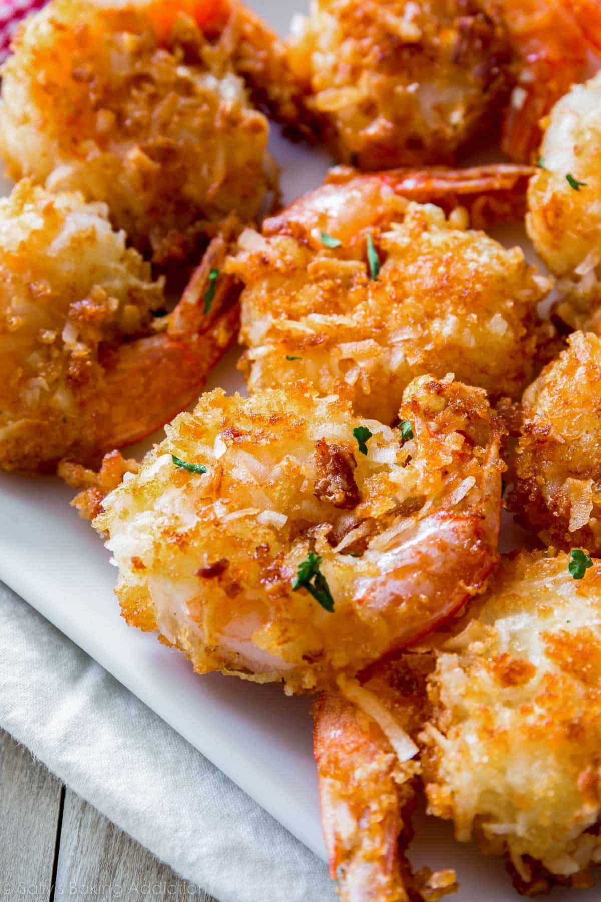 several coconut shrimp with parsley sprinkled on top.