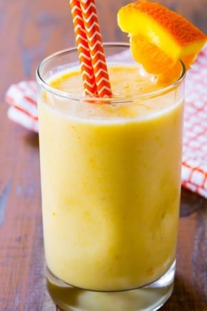 creamsicle smoothie in a glass with straws