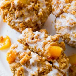 peach streusel muffins on a white plate
