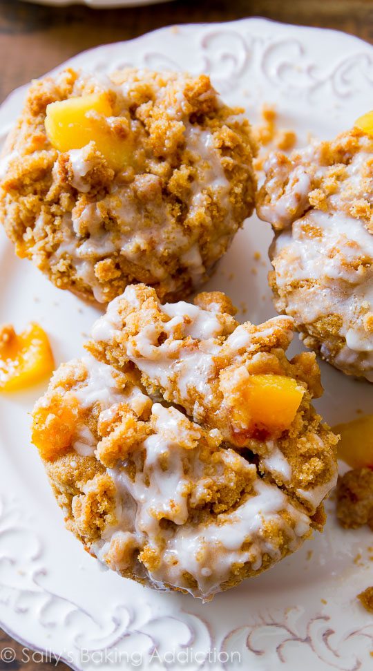 peach streusel muffins on a white plate