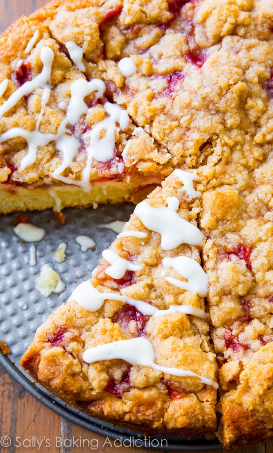 slice of glazed strawberry crumb cake in a baking pan
