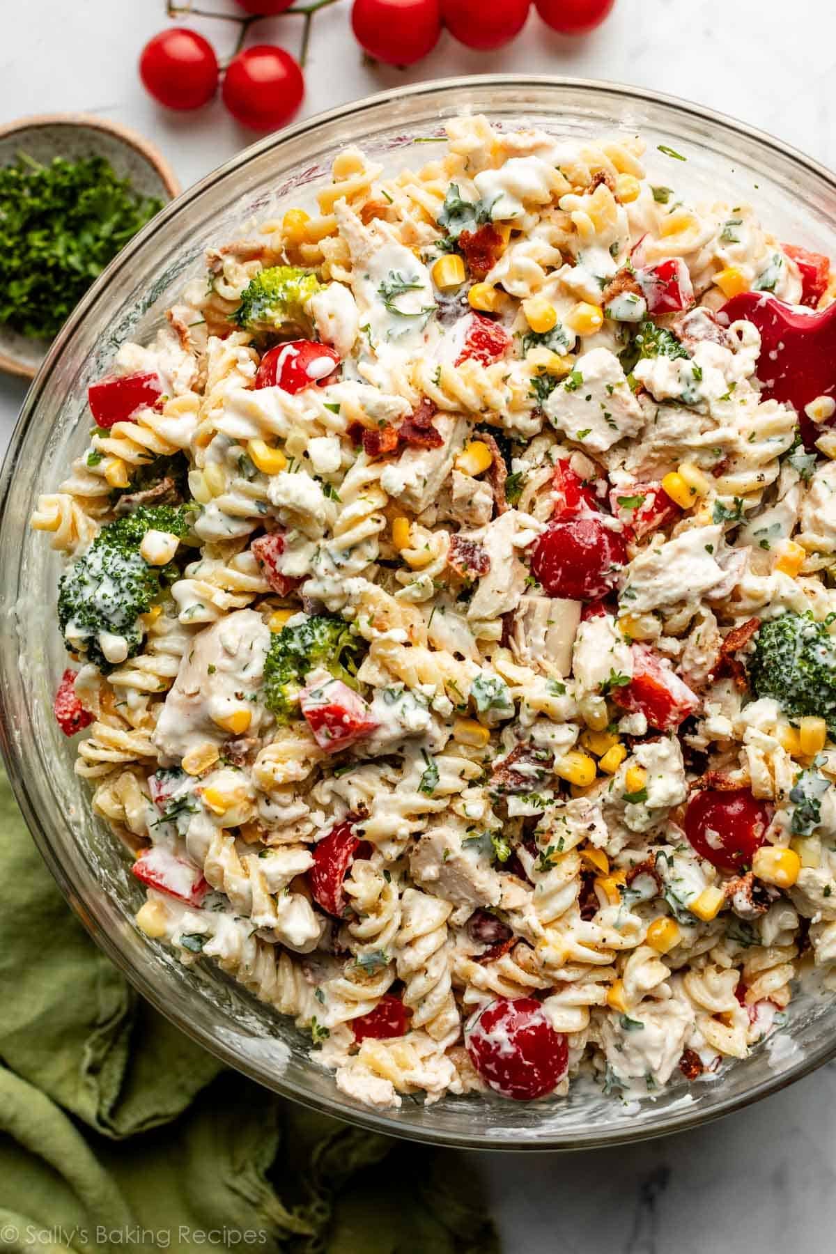 large glass bowl of chicken pasta salad with creamy dressing all over it.