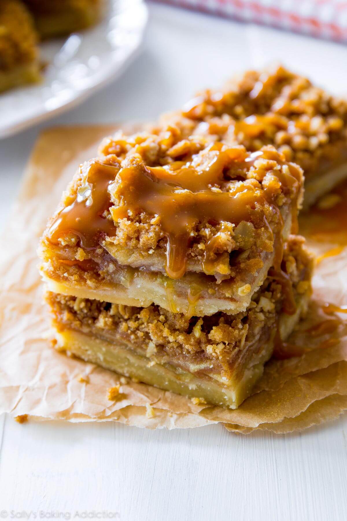 stack of apple pie bars with salted caramel sauce on top