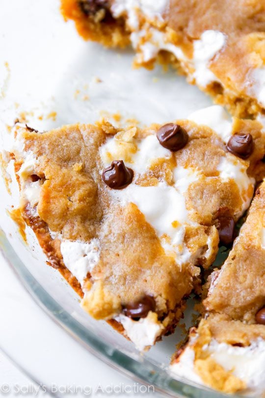 s'mores chocolate chip cookie cake in a glass baking dish