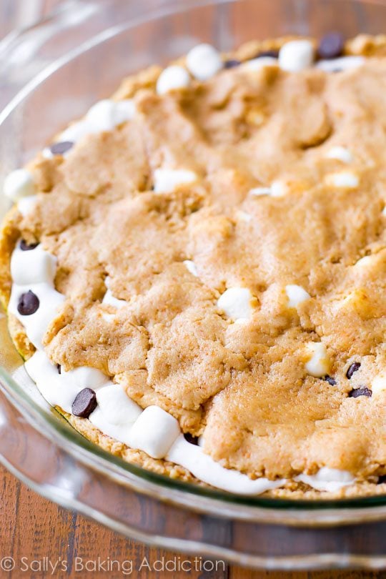 s'mores chocolate chip cookie cake in a glass baking dish
