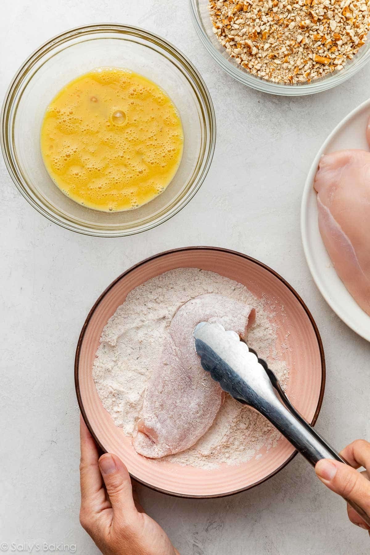dredging the chicken breast in flour.