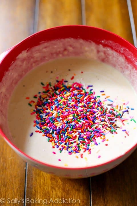 funfetti pancake batter with sprinkles in a red bowl