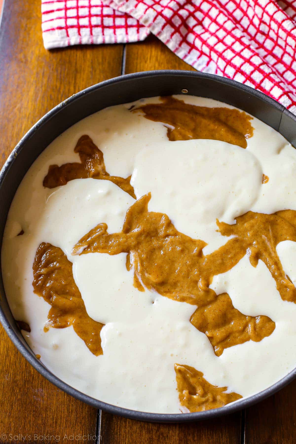 pumpkin cake and cheesecake batter swirled together in a springform pan