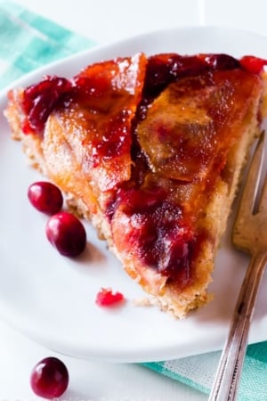 slice of cranberry apple upside down cake on a white plate