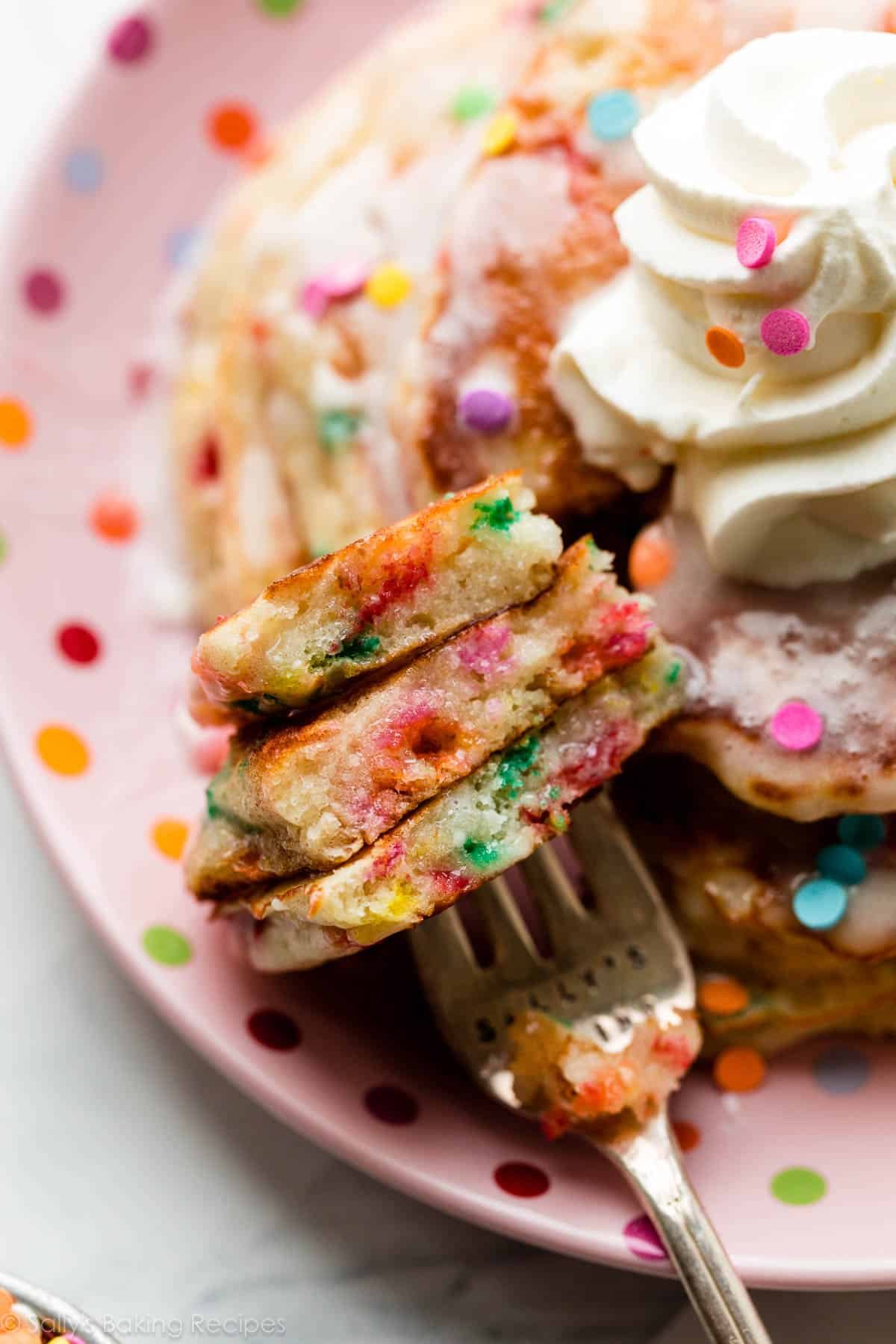 close-up photo of forkful of sprinkle birthday cake pancakes.