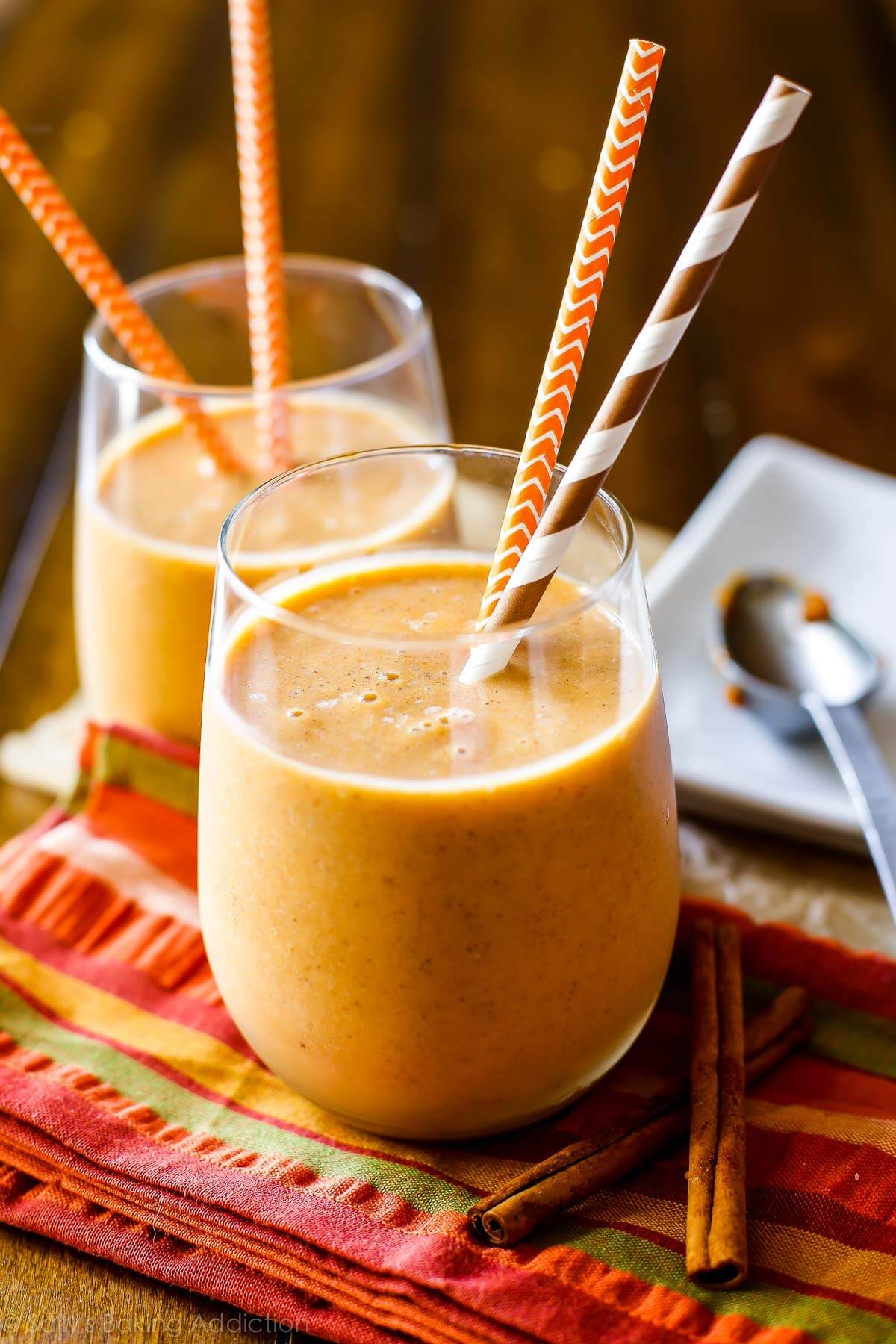 pumpkin protein smoothie in glass cups with straws