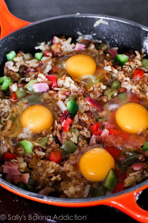 crispy hash breakfast skillet with eggs on top before baking