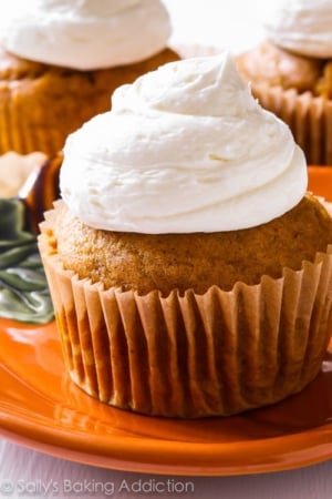 pumpkin cupcakes with marshmallow frosting on an orange plate