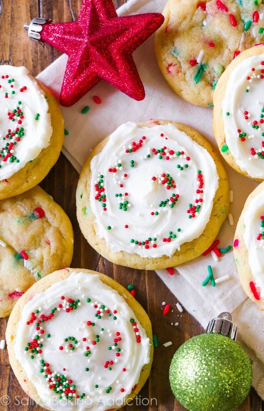 overhead image of sugar cookies topped with frosting and red and green sprinkles