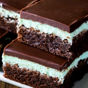 stack of mint chocolate brownies on a white serving tray
