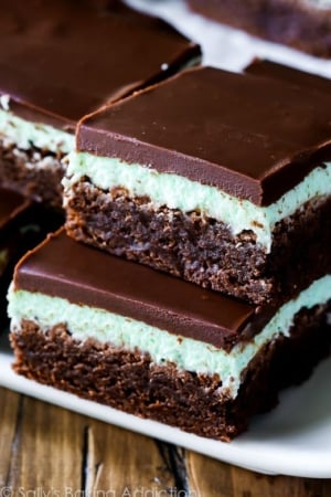 stack of mint chocolate brownies on a white serving tray