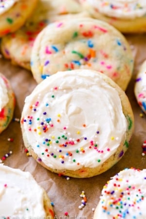 sugar cookies with sprinkles topped with vanilla frosting and sprinkles