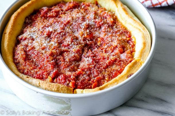 deep dish pizza in a baking pan after baking