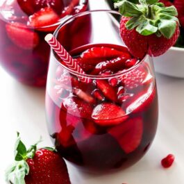 strawberry pomegranate sangria in glasses with straws