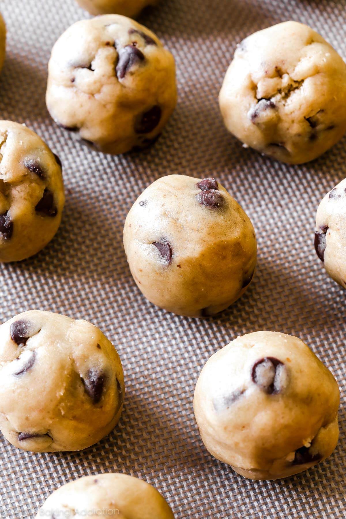 brown butter chocolate chip cookie dough balls on a silpat baking mat