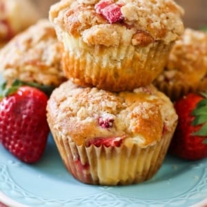 stack of strawberry cheesecake muffins on a blue plate