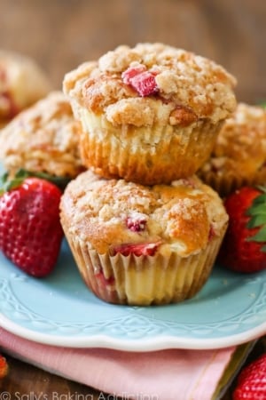 stack of strawberry cheesecake muffins on a blue plate