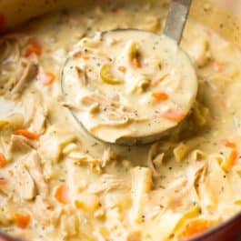Homemade creamy chicken noodle soup in a pot.