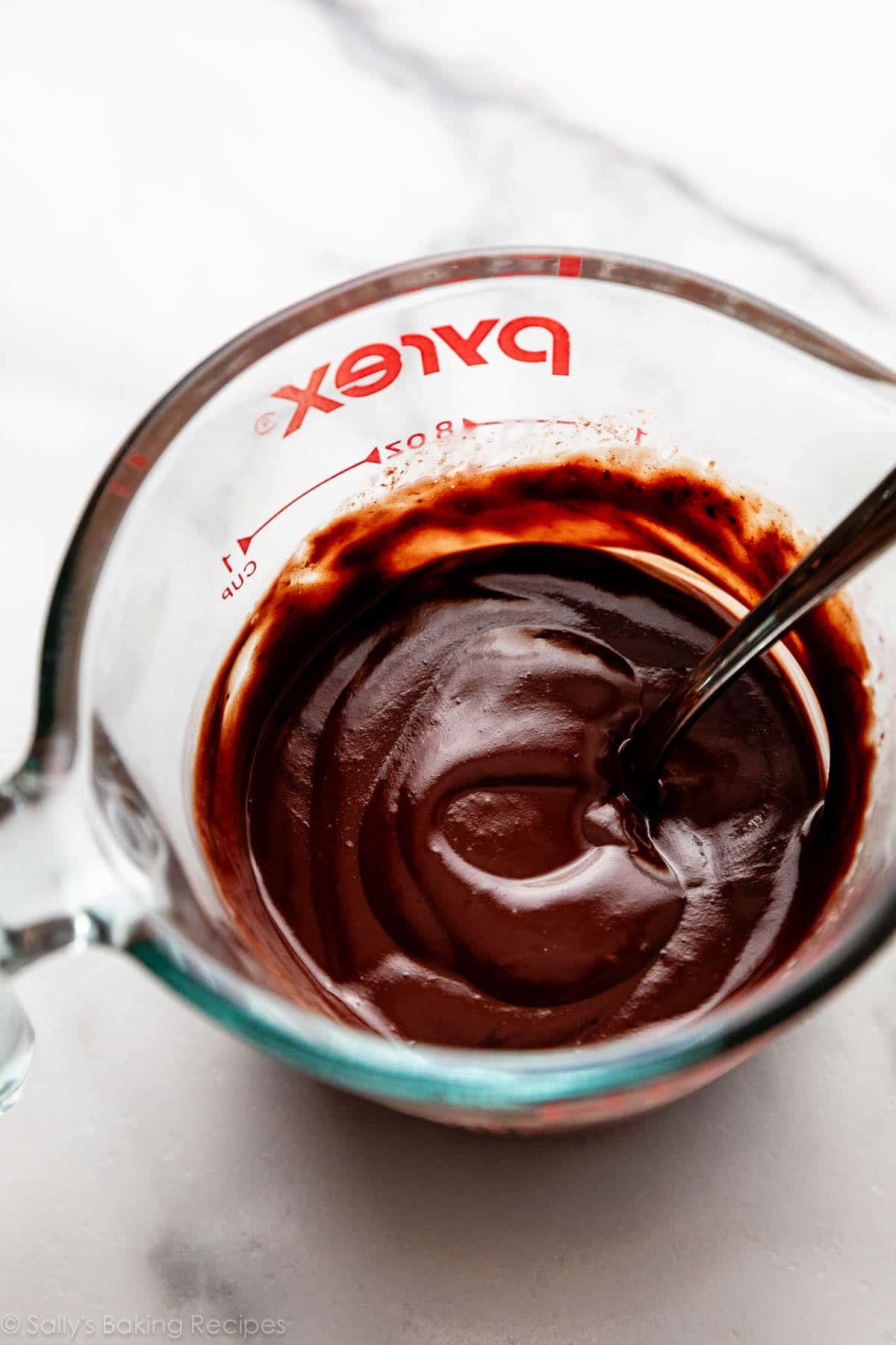 melted chocolate in glass liquid measuring cup.